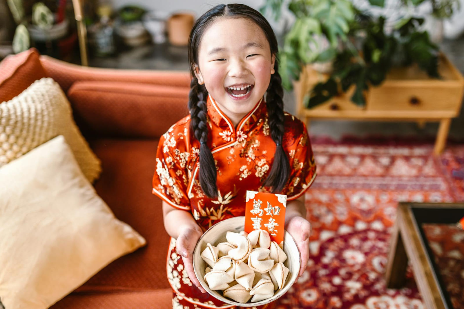 Child celebrating Lunar New Year with fortune cookies