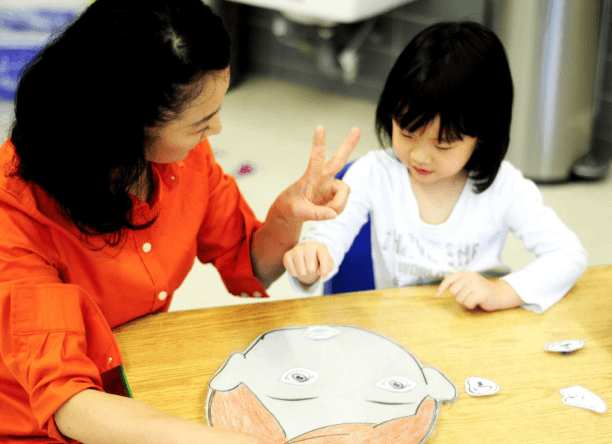Child learning with a teacher