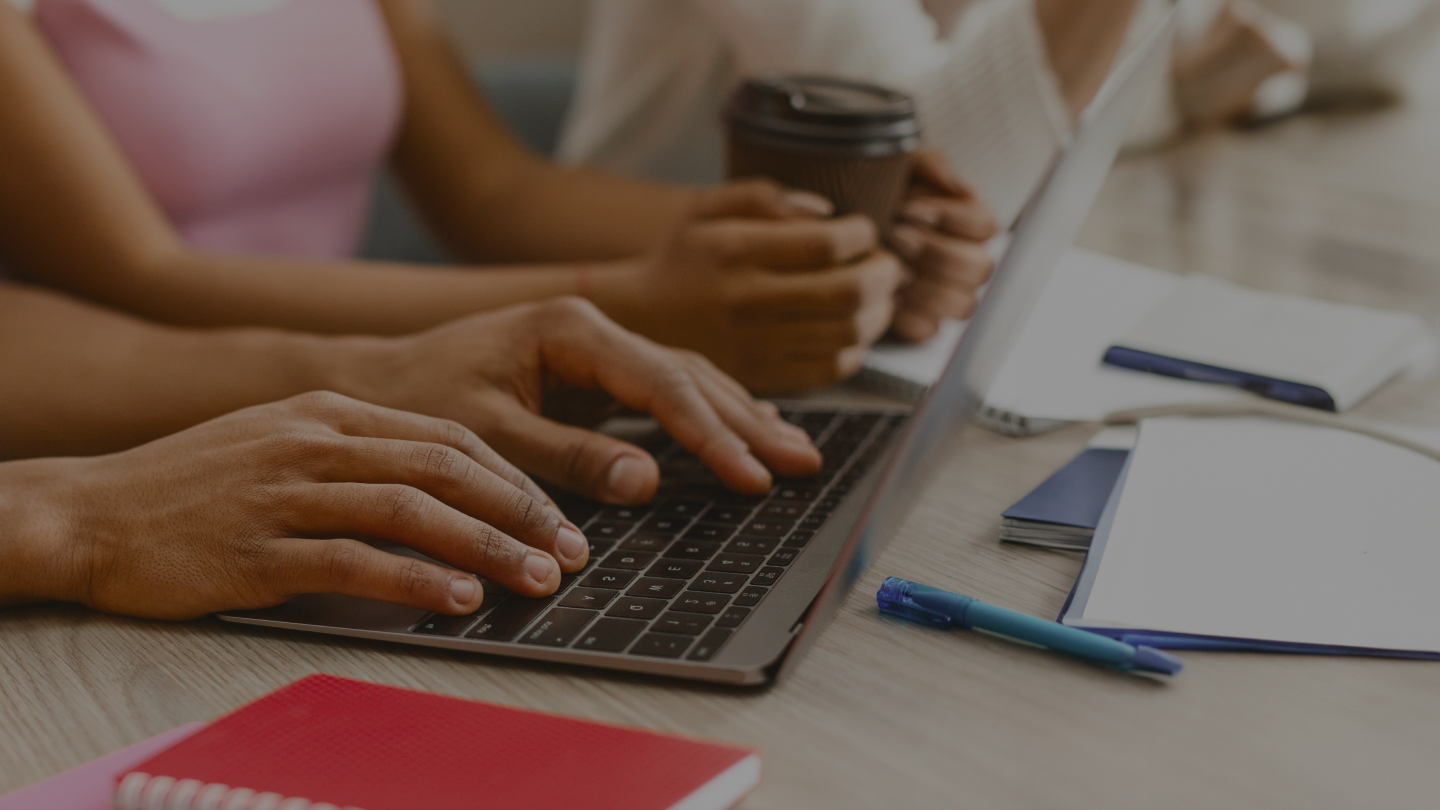 Hands writing a blog article